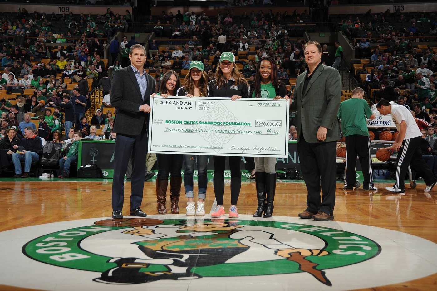 Deidre Osei presenting a $250,000 Charity by Design donation to the Boston Celtics Shamrock Foundation